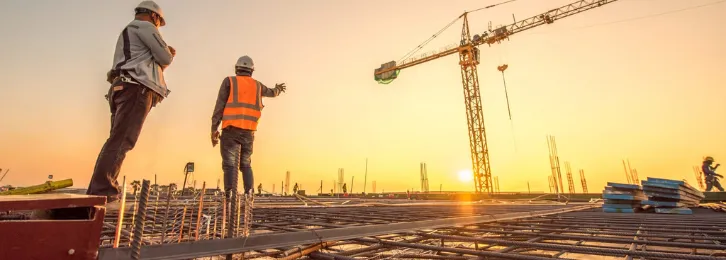 Engineers and a tower crane on a construction site